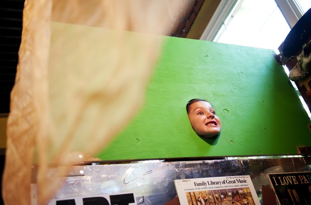 Ann Arbor resident Grace Heard, 6, sticks her head through the Heidelberg Project mobile video booth at the last Shadow Art Fair at the Corner Brewery in Ypsilanti on Saturday, July 20. Daniel Brenner I AnnArbor.com